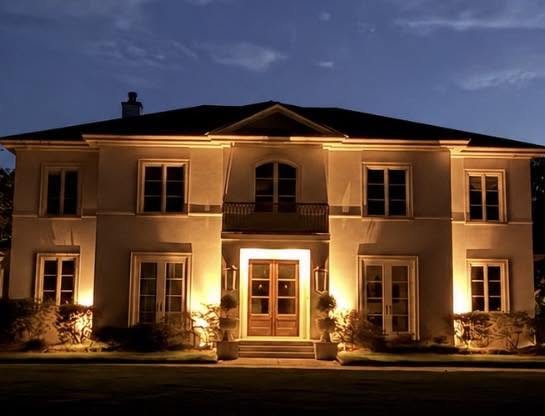 White estate facade washed in warm light